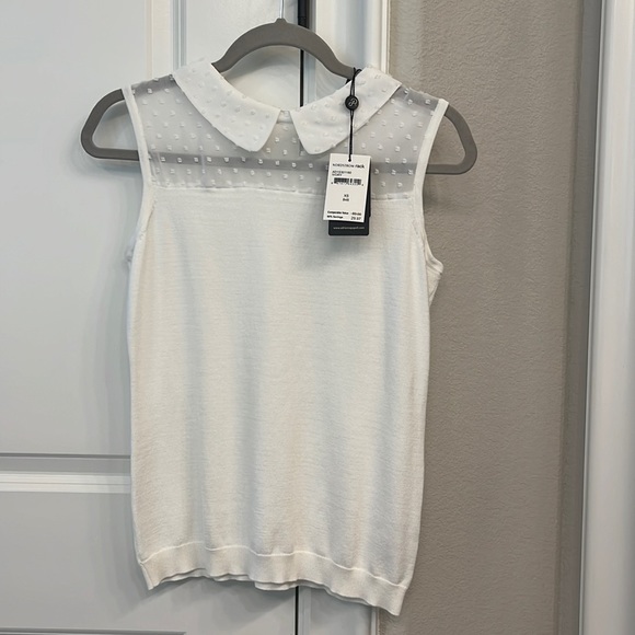 Lightweight sleeveless knit top with sheer accents around the collar. - Picture 1 of 5
